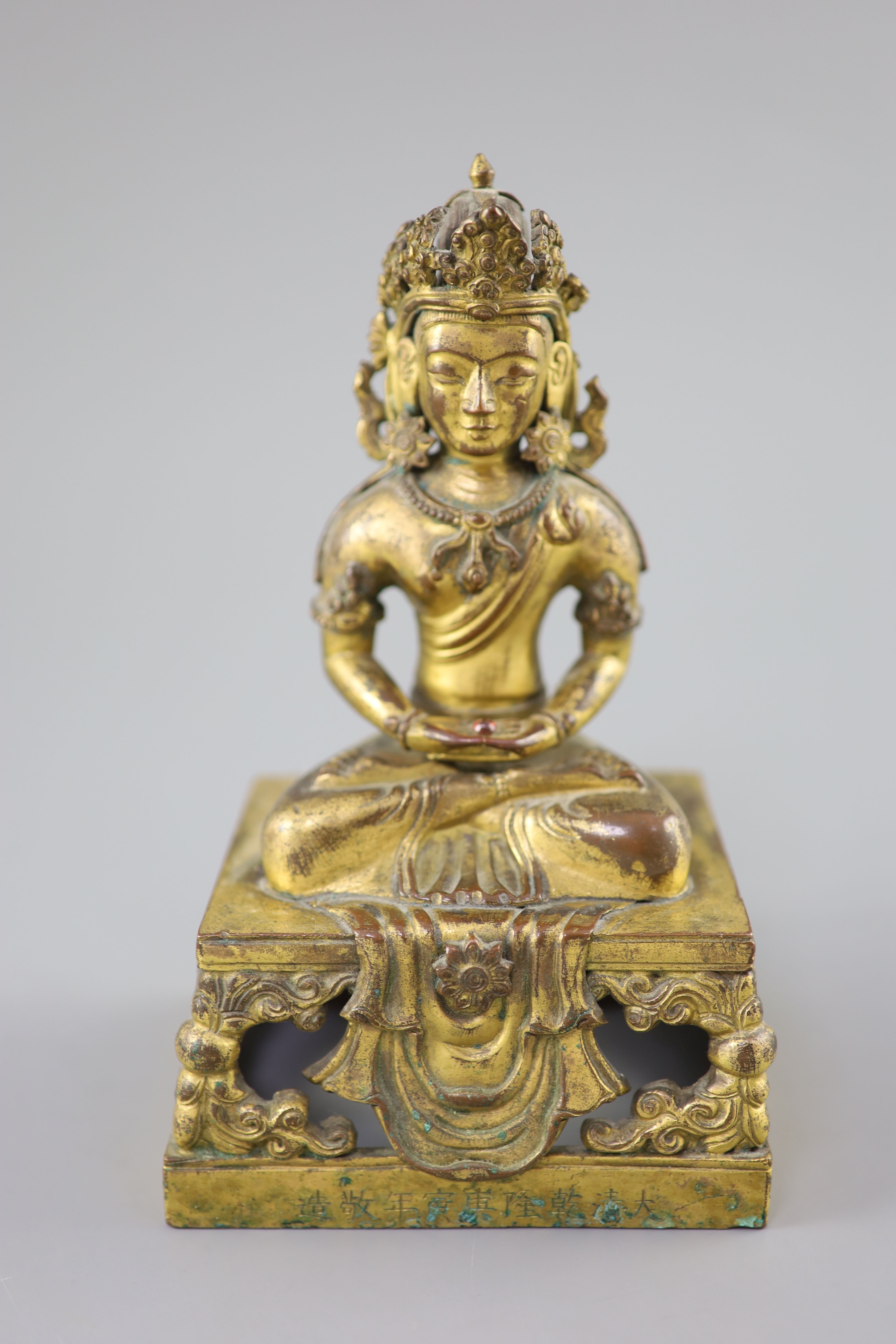 A Chinese gilt bronze seated figure of Amitayus, Qianlong period, dated 1770, Provenance - A. T. Arber-Cooke